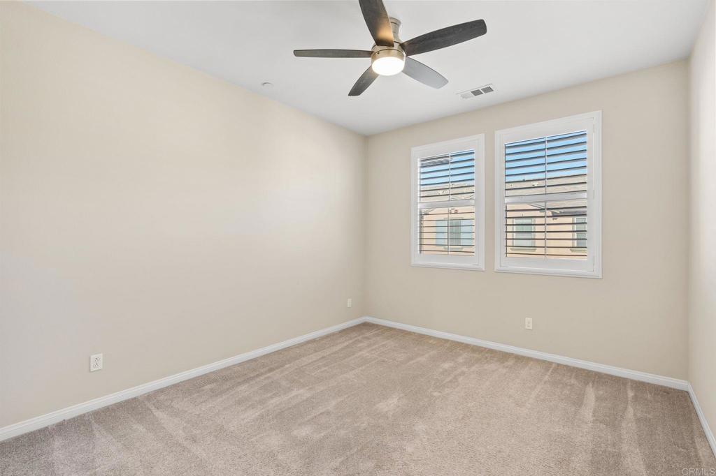 15968 Parkview Loop San Diego, CA 92127 - Photo 18 of 45 an empty room with a window and a fan