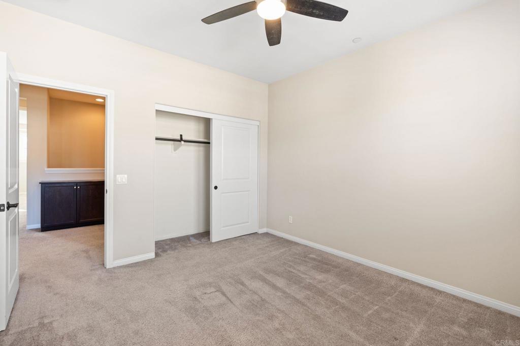 15968 Parkview Loop San Diego, CA 92127 - Photo 19 of 45 an empty room with closet and windows