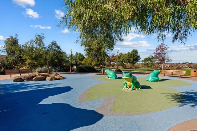 a view of a swimming pool with a yard and palm trees