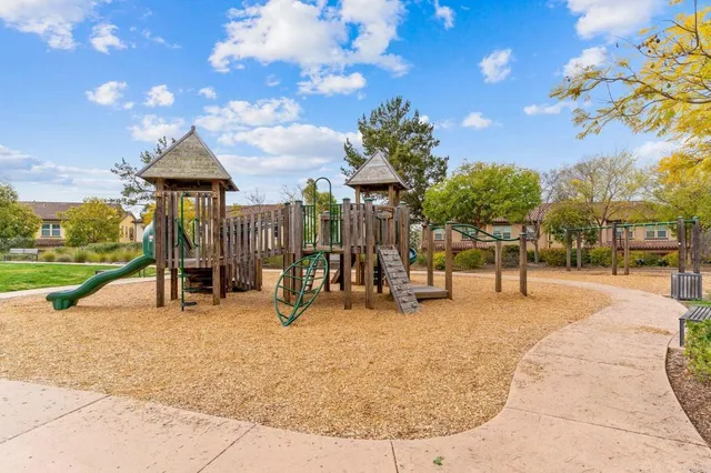 a view of a park with swings and slides