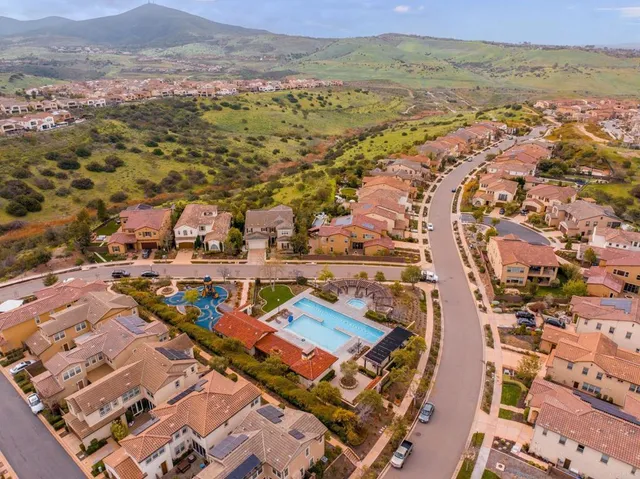an aerial view of residential houses with outdoor space