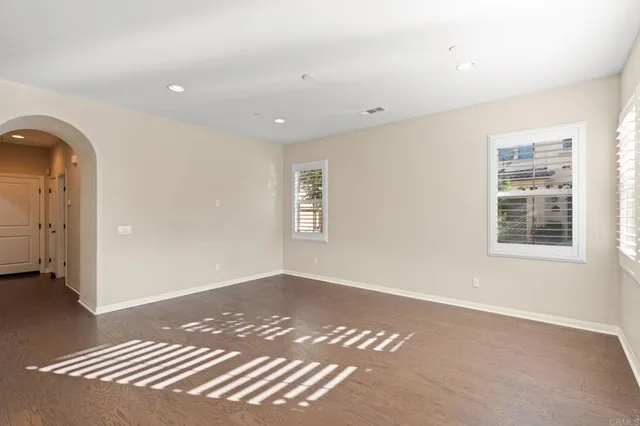 a view of wooden floor and windows in a room