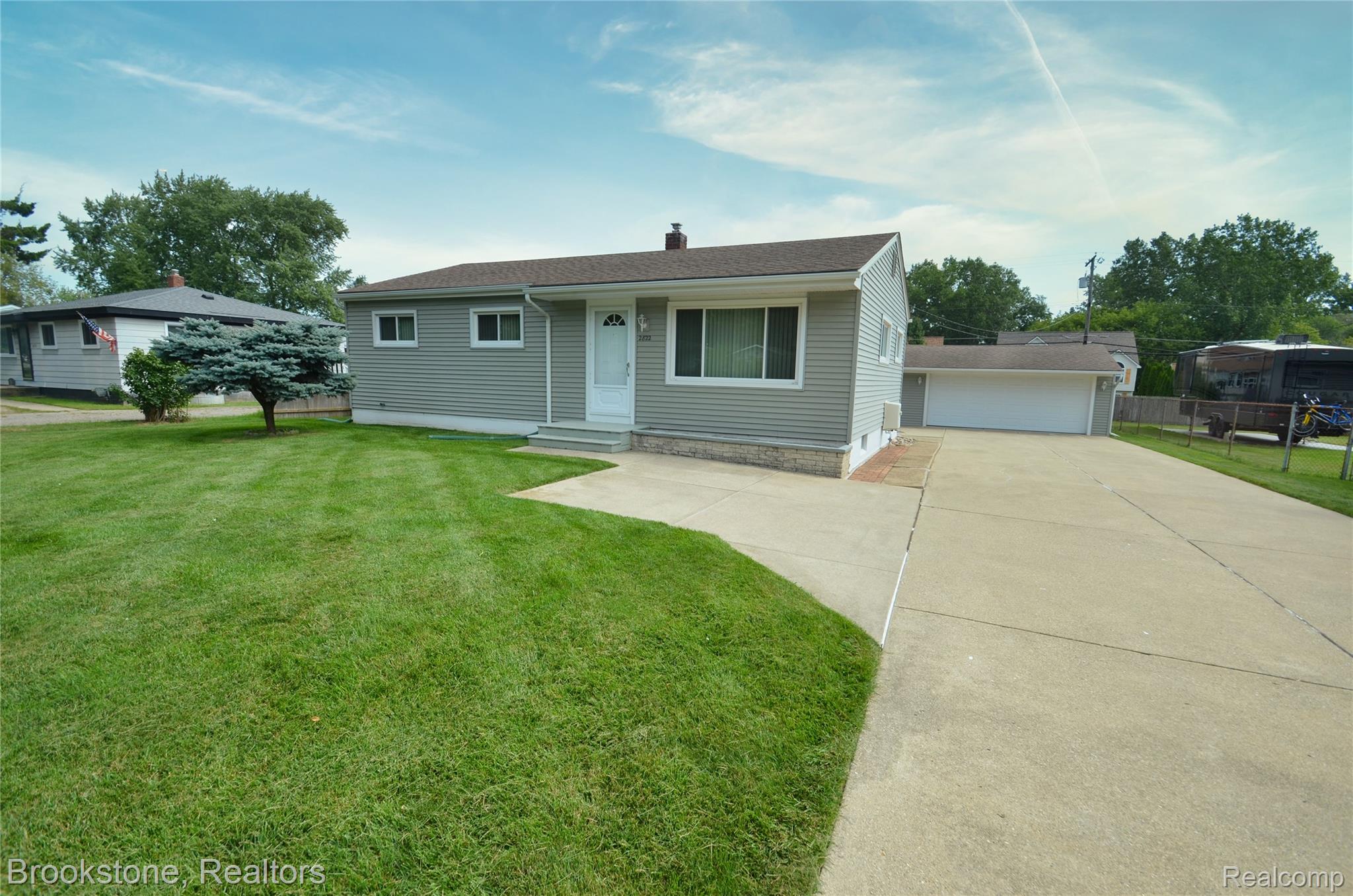 2822 Frembes Road Waterford, MI 48329 - Photo 25 of 25 Siding exterior, concrete driveway, attached garage, manicured lawn, and mature landscaping