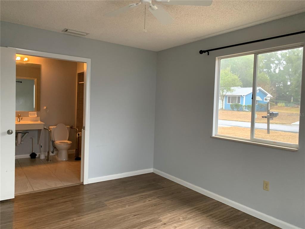 8431 Southwest 109th Lane Road Ocala, FL 34481 - Photo 14 of 20 a view of a room with wooden floor and a window