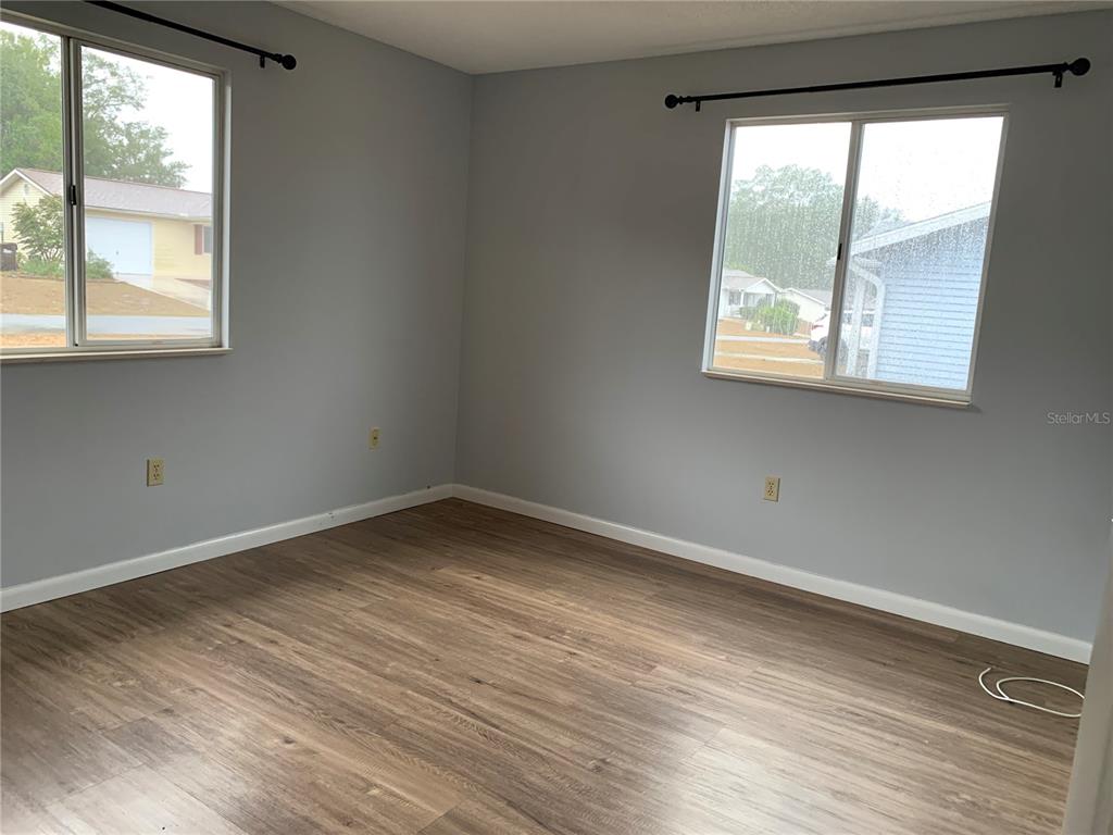 8431 Southwest 109th Lane Road Ocala, FL 34481 - Photo 15 of 20 an empty room with wooden floor and windows