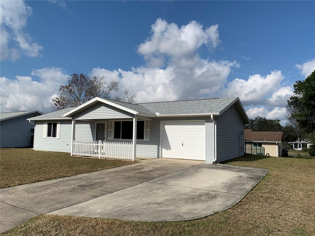 8431 Southwest 109th Lane Road Ocala, FL 34481 - Photo 2 of 20 a front view of a house with a yard and garage