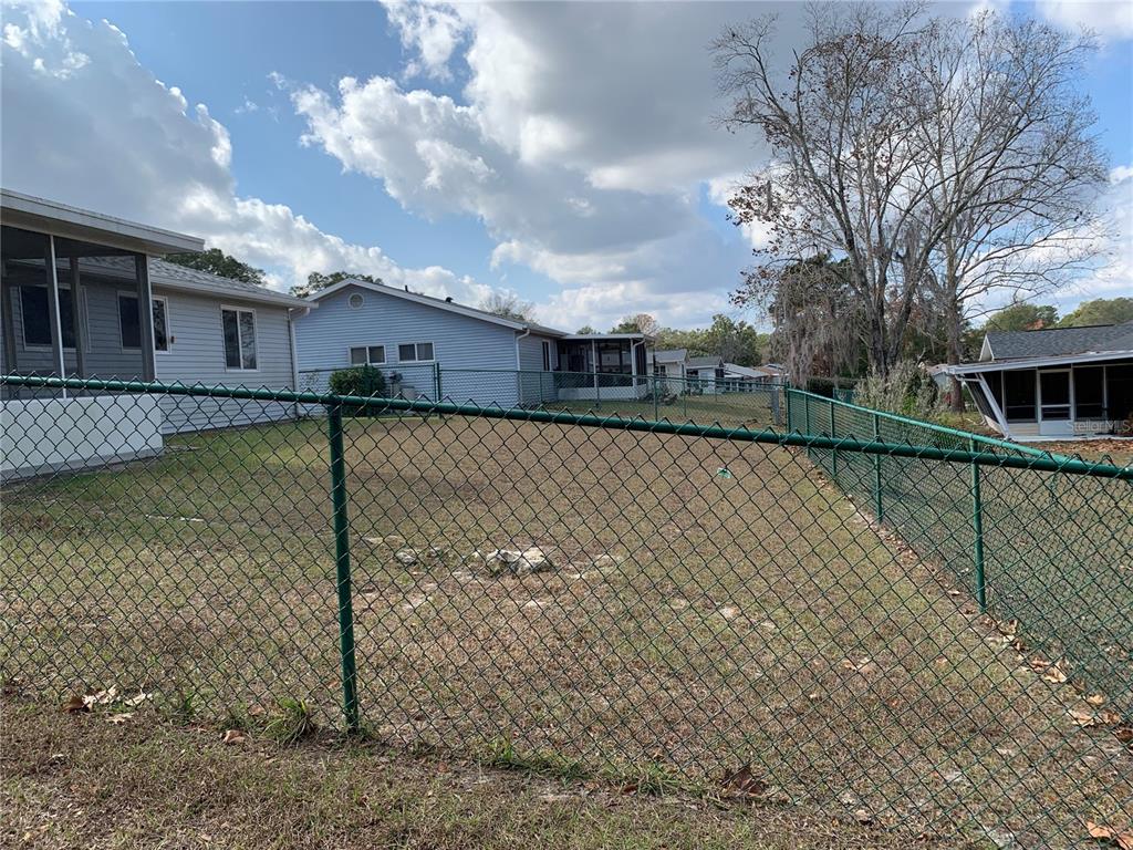 8431 Southwest 109th Lane Road Ocala, FL 34481 - Photo 4 of 20 a view of a house with a wooden fence