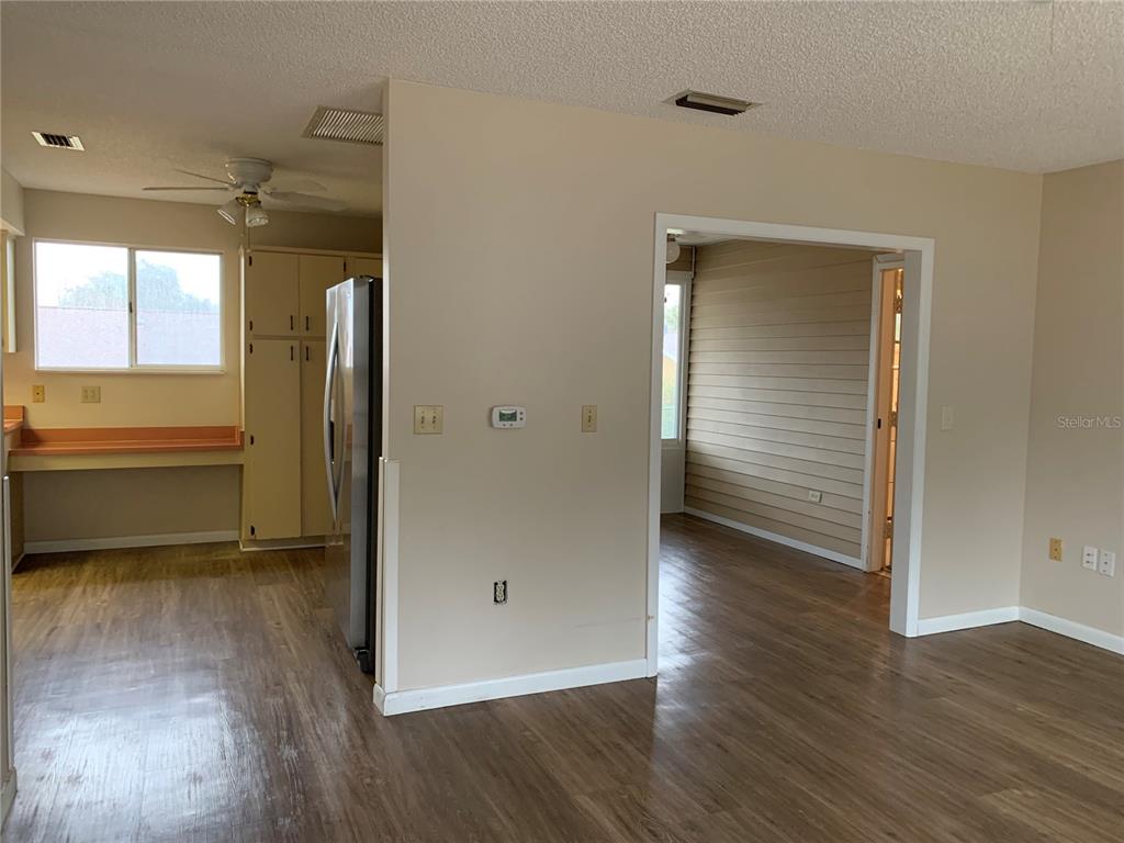 8431 Southwest 109th Lane Road Ocala, FL 34481 - Photo 6 of 20 an empty room with wooden floor and a window