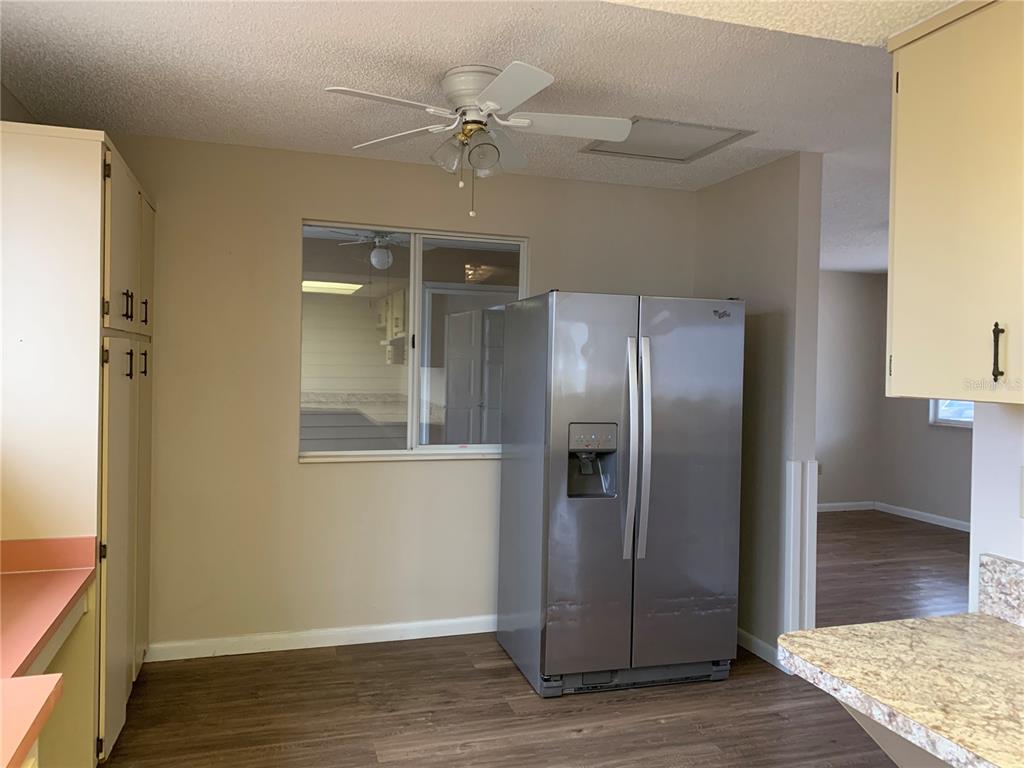 8431 Southwest 109th Lane Road Ocala, FL 34481 - Photo 10 of 20 a view of a refrigerator in kitchen and an empty room
