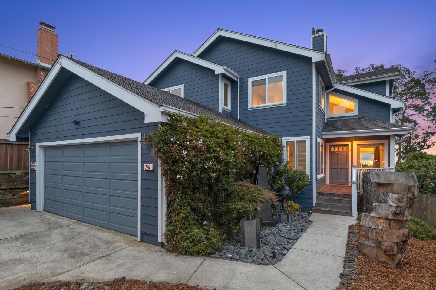 a front view of a house with garden