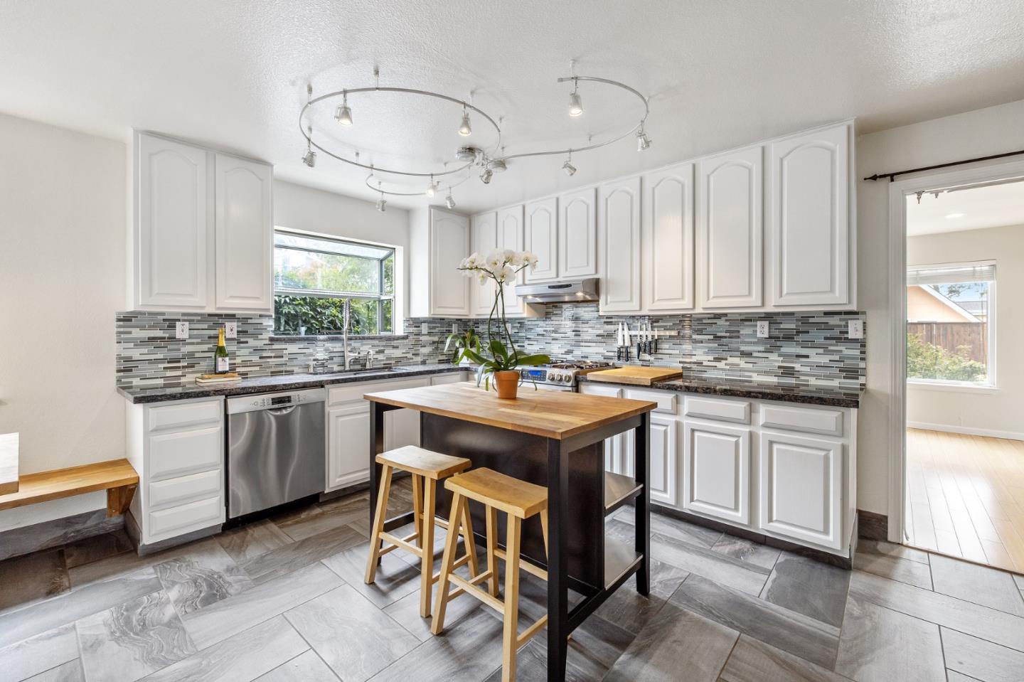 226 Palma Street El Granada, CA 94018 - Photo 11 of 41 a kitchen with kitchen island granite countertop a sink counter top space appliances and cabinets