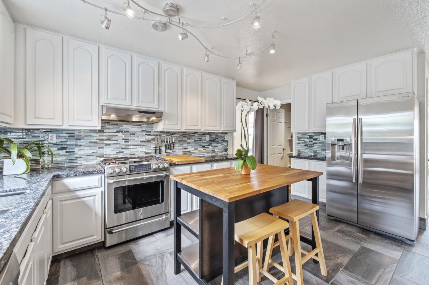 226 Palma Street El Granada, CA 94018 - Photo 12 of 41 a kitchen with a stove a sink and a refrigerator