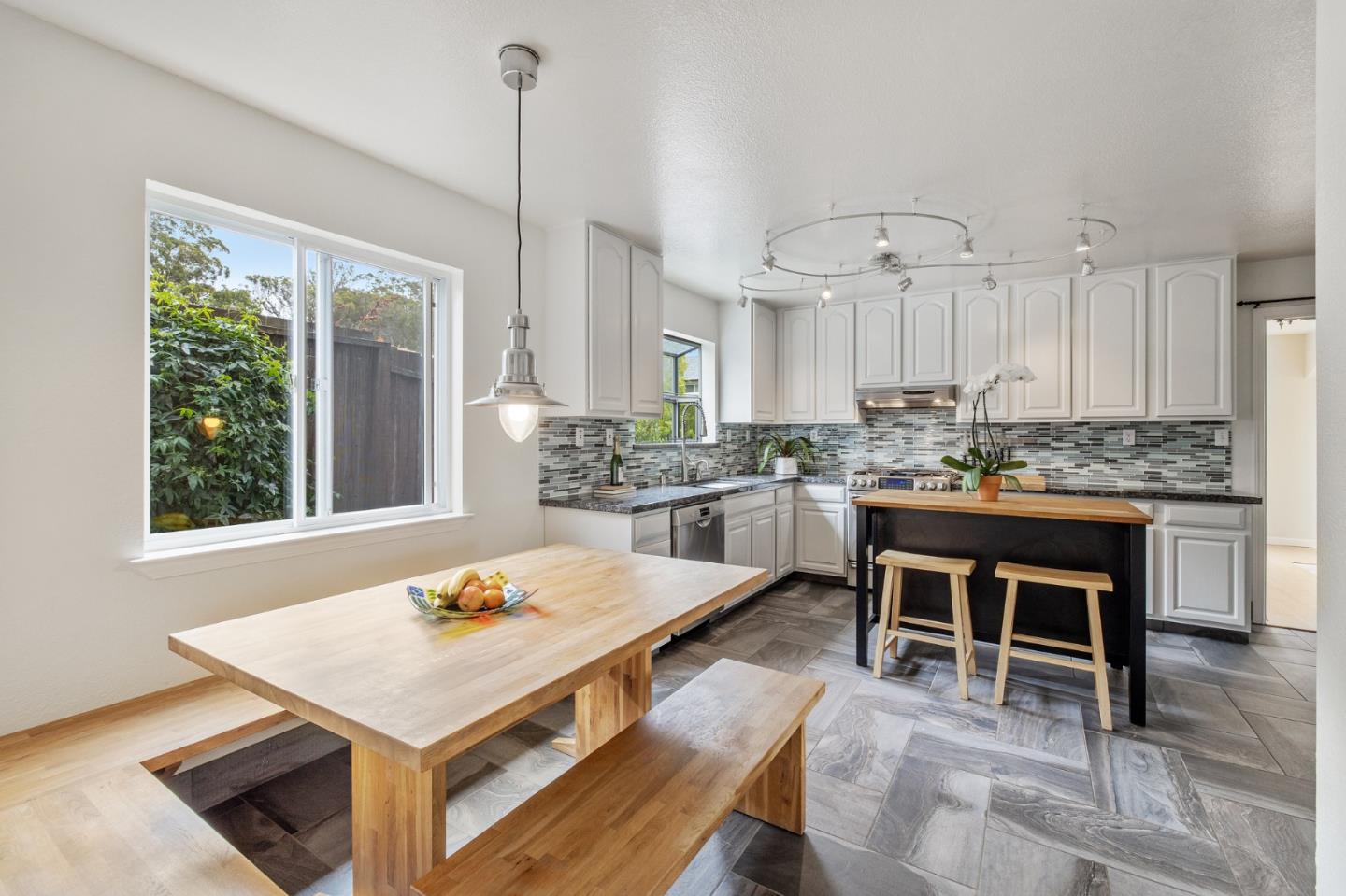 226 Palma Street El Granada, CA 94018 - Photo 15 of 41 a kitchen with a table chairs sink and cabinets