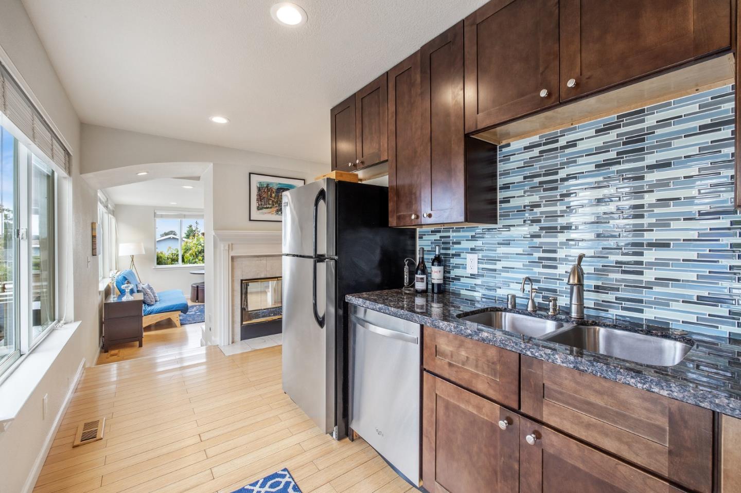226 Palma Street El Granada, CA 94018 - Photo 22 of 41 a kitchen with stainless steel appliances granite countertop a refrigerator and a sink