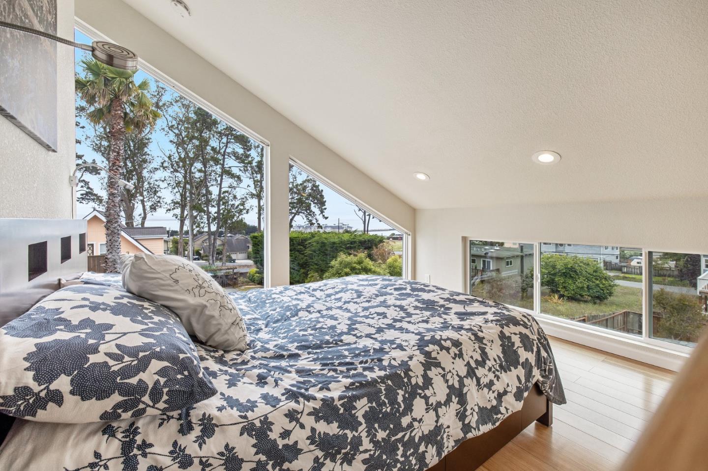 226 Palma Street El Granada, CA 94018 - Photo 27 of 41 a bed sitting in a spacious bedroom next to a large window