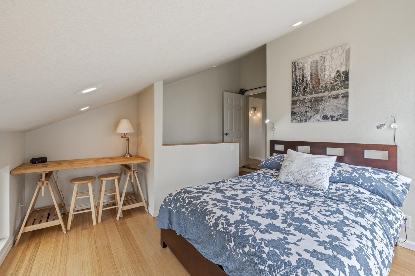 226 Palma Street El Granada, CA 94018 - Photo 28 of 41 a bedroom with a bed and wooden floor