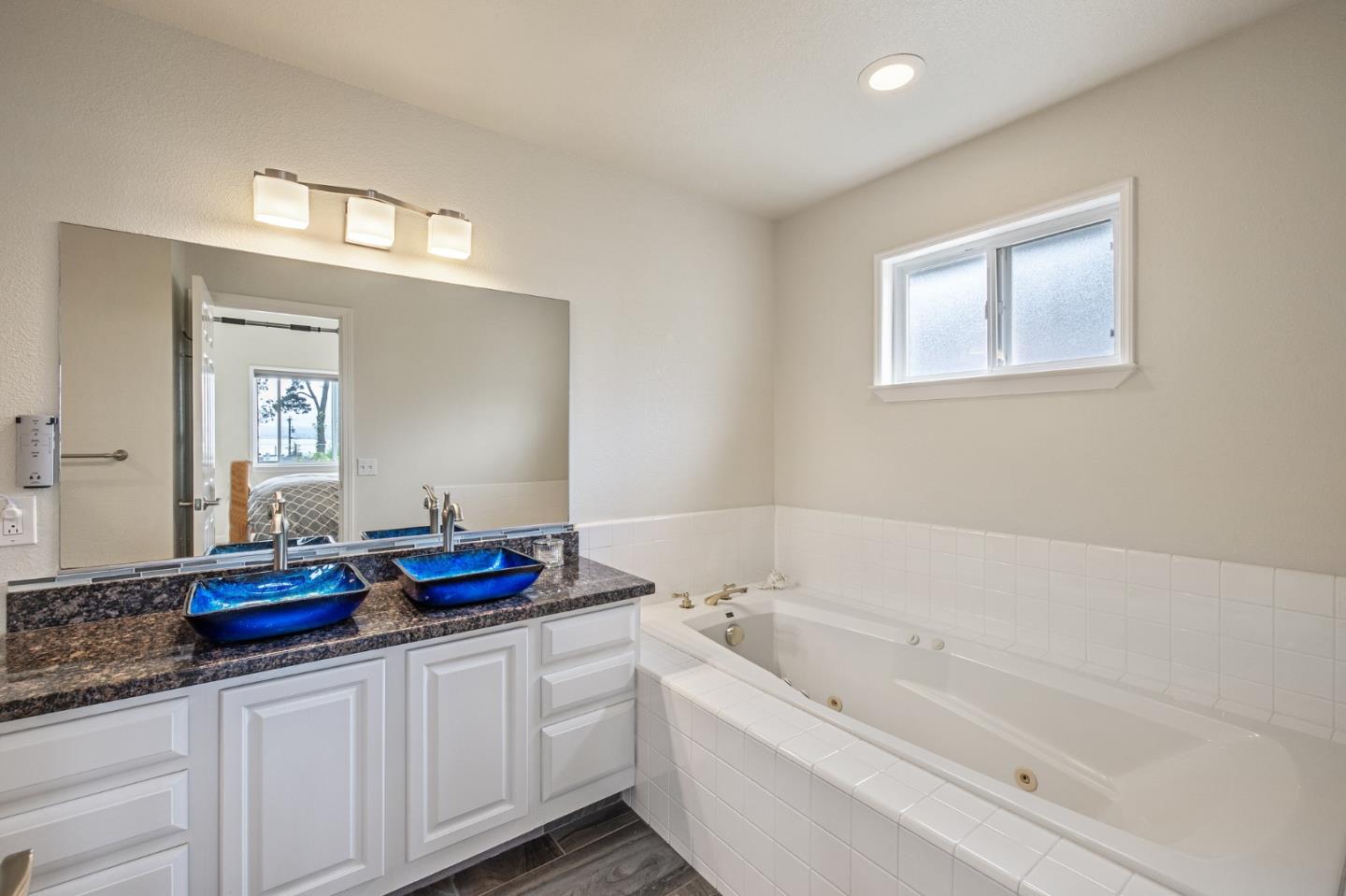 226 Palma Street El Granada, CA 94018 - Photo 33 of 41 a bathroom with a tub sink and mirror