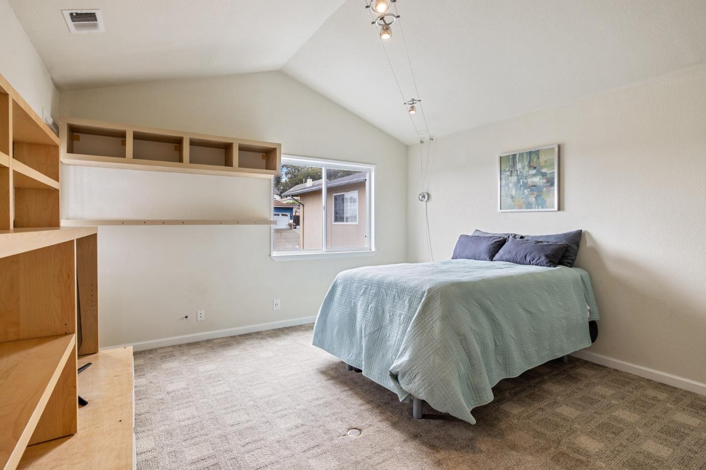 226 Palma Street El Granada, CA 94018 - Photo 36 of 41 a spacious bedroom with a bed and a cabinets
