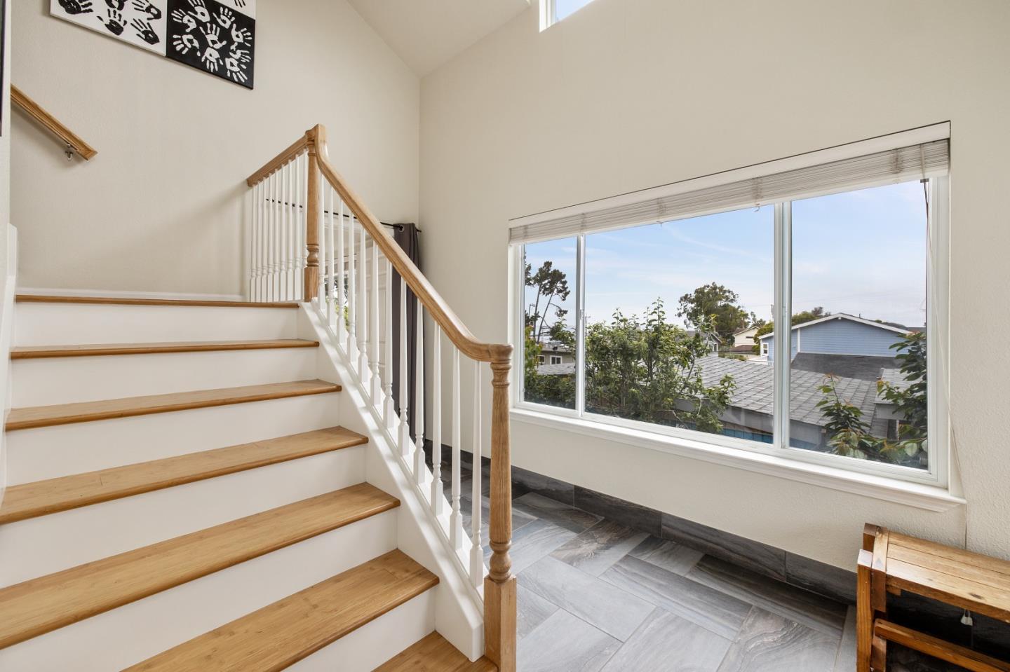 226 Palma Street El Granada, CA 94018 - Photo 8 of 41 a view of staircase with white walls and a window