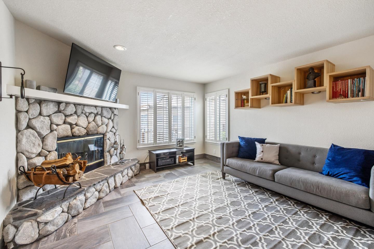 226 Palma Street El Granada, CA 94018 - Photo 10 of 41 a living room with furniture a fireplace and a flat screen tv
