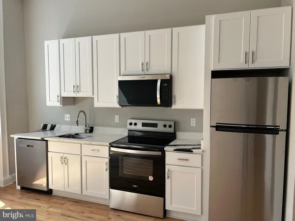a white refrigerator freezer sitting inside of a kitchen