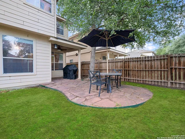 a table and chairs sitting in backyard of house
