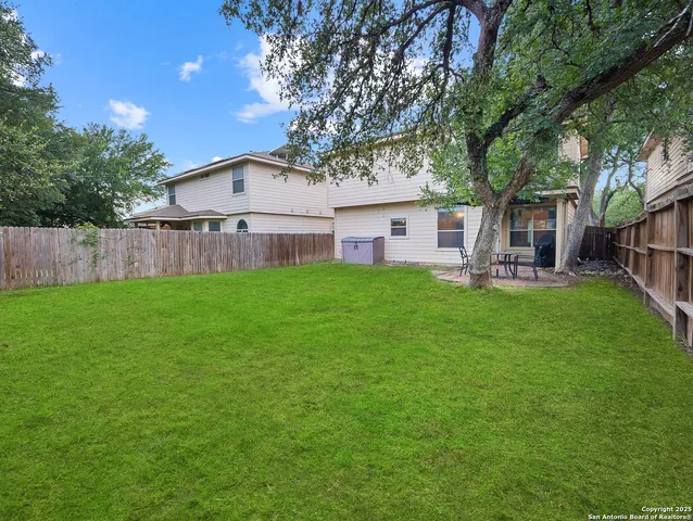 a view of a house with a yard and sitting area