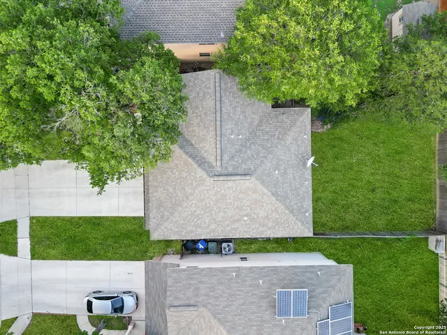 an aerial view of a house with a yard