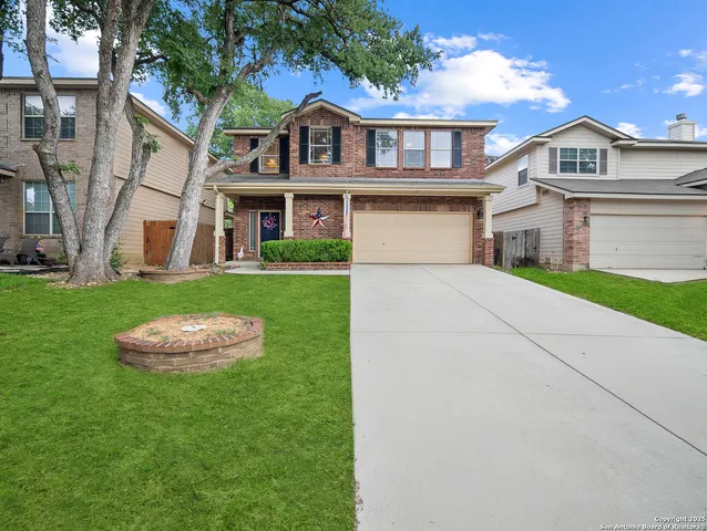 a front view of a house with a garden and yard