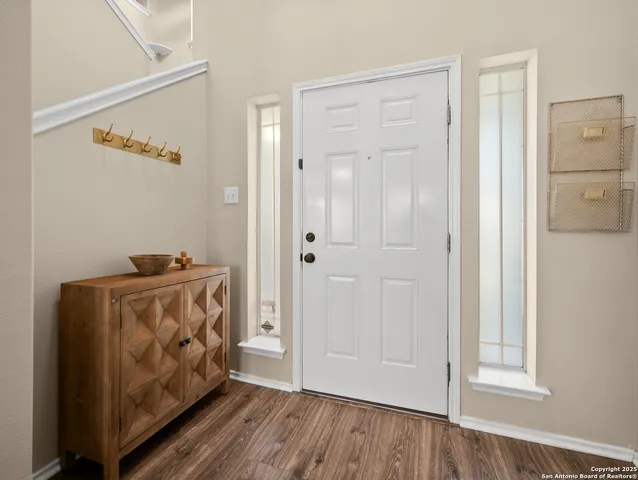 a view of an entryway with wooden floor