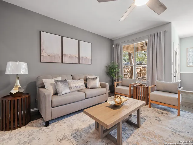 a living room with furniture and a large window