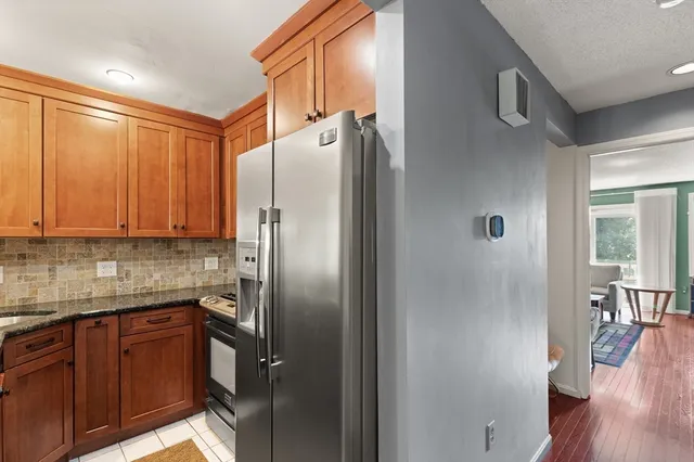 a kitchen with stainless steel appliances granite countertop a refrigerator and a sink