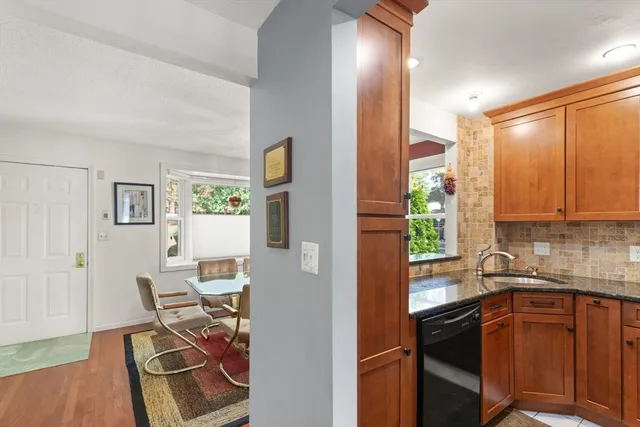 a kitchen with stainless steel appliances granite countertop a refrigerator and a sink