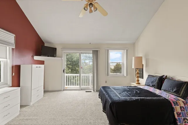 a bed room with a bed and a large window