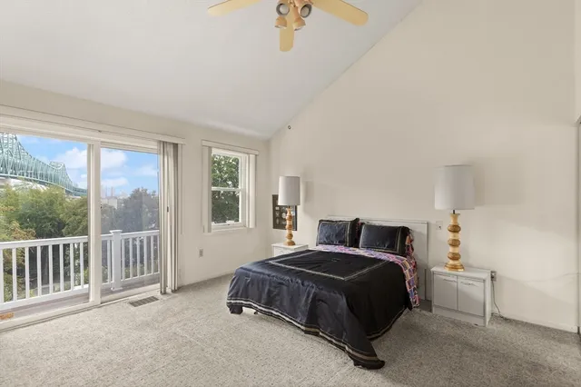 a bedroom with a bed and a large window