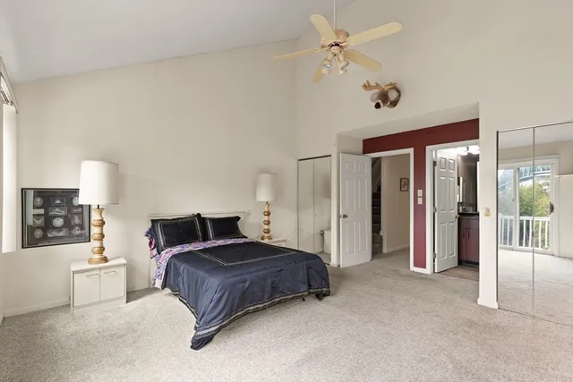a bedroom with a large bed and a chandelier