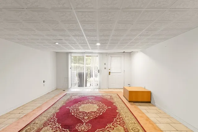 a spacious bedroom with a bed and wooden floor