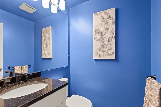 a bathroom with a sink toilet and mirror