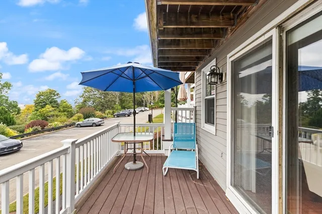 a view of balcony with wooden floor and outdoor seating