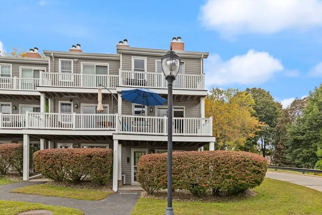 a view of a big house with wooden fence