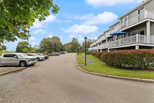 a view of a street with a car parked in the background