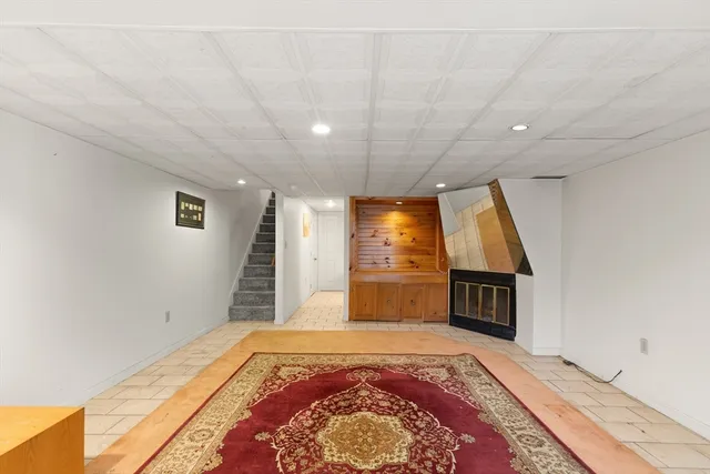 a spacious bedroom with a bed and a television