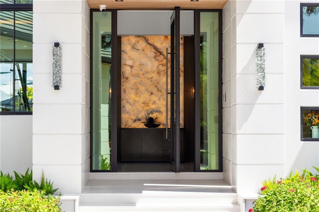 2345 Tarpon Road Naples, FL 34102 - Photo 2 of 43 View of exterior entry with stone siding and stucco siding