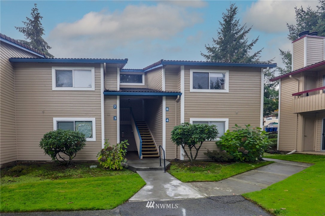 17518 149th Avenue Southeast, Unit 8 Renton, WA 98058 - Photo 1 of 25 a front view of a house with a yard and garage