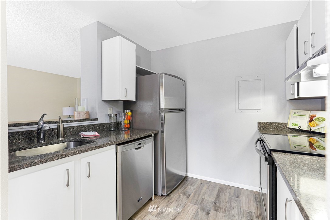 17518 149th Avenue Southeast, Unit 8 Renton, WA 98058 - Photo 11 of 25 a kitchen with stainless steel appliances granite countertop a sink stove and refrigerator