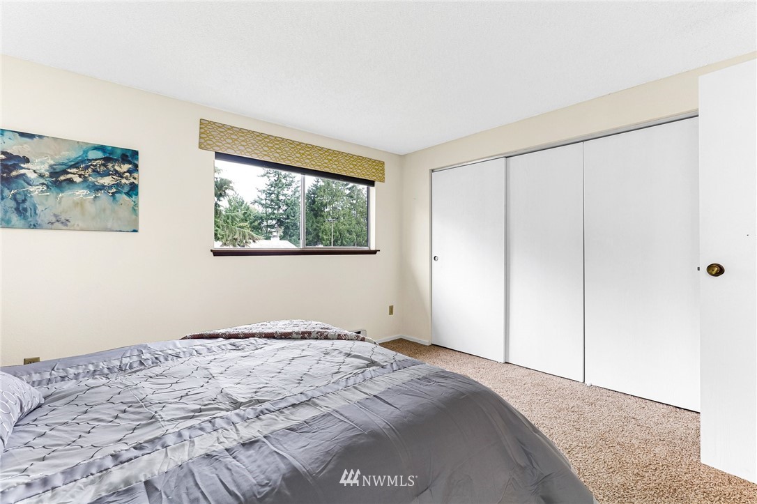 17518 149th Avenue Southeast, Unit 8 Renton, WA 98058 - Photo 15 of 25 a bedroom with a bed and a window