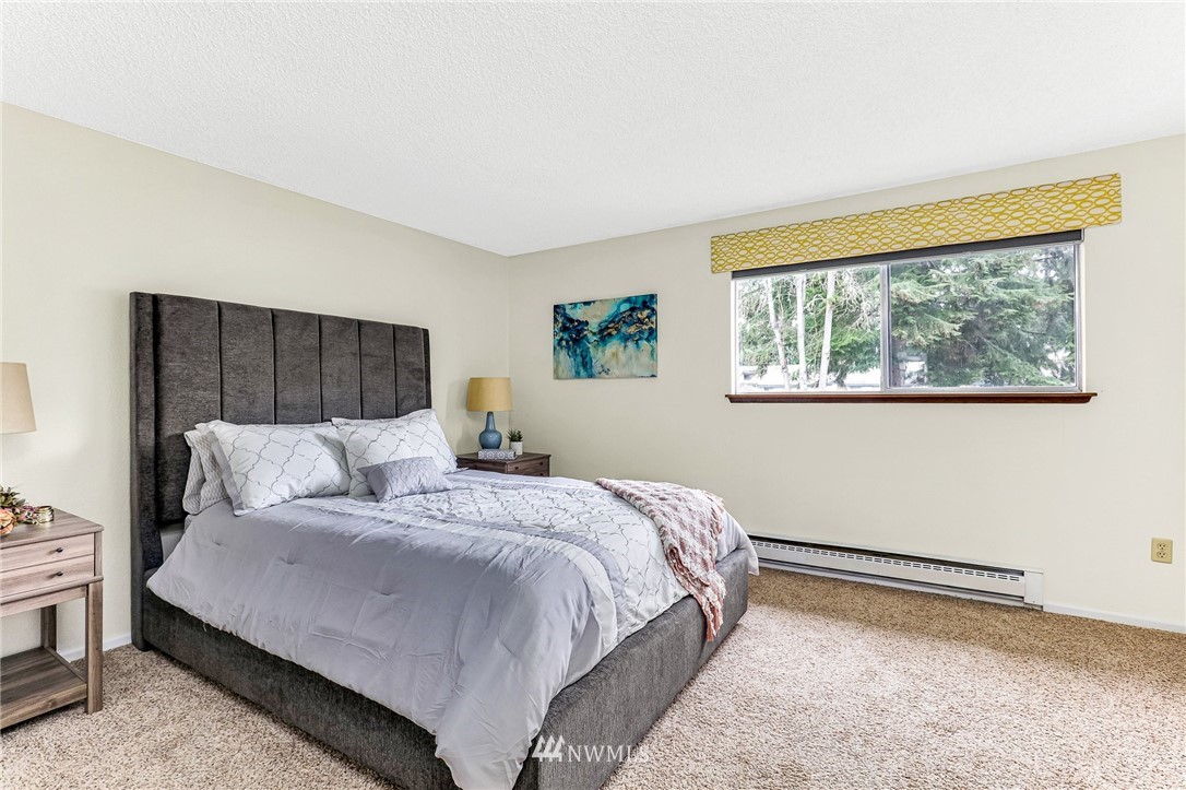 17518 149th Avenue Southeast, Unit 8 Renton, WA 98058 - Photo 16 of 25 a bedroom with a large bed and a window