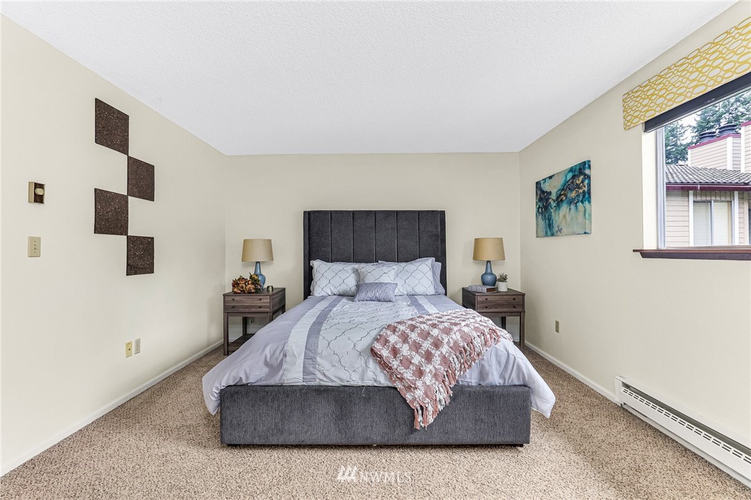 17518 149th Avenue Southeast, Unit 8 Renton, WA 98058 - Photo 18 of 25 a bedroom with a bed and a painting on the wall