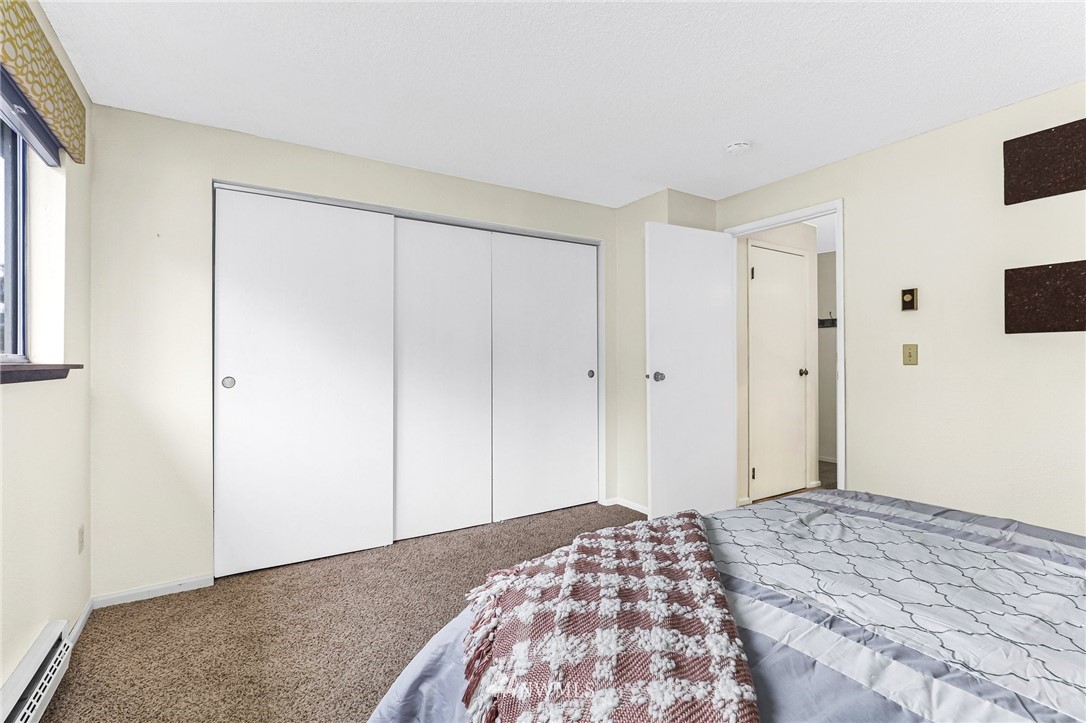17518 149th Avenue Southeast, Unit 8 Renton, WA 98058 - Photo 19 of 25 a bedroom with a bed and a cabinet