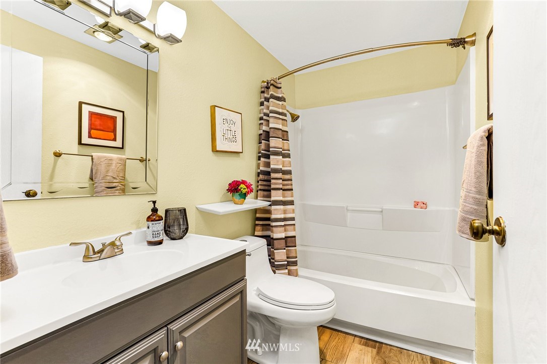 17518 149th Avenue Southeast, Unit 8 Renton, WA 98058 - Photo 21 of 25 a bathroom with a sink vanity mirror and toilet